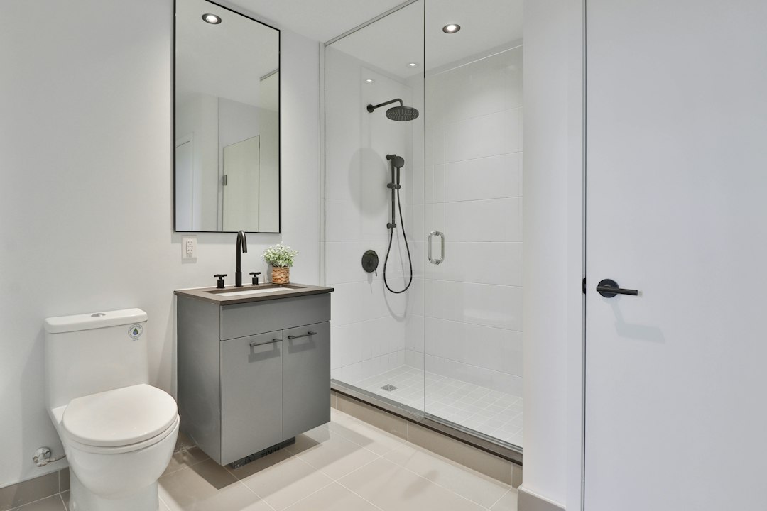 Bathroom with a glass enclosed shower and coordinated tile finishes